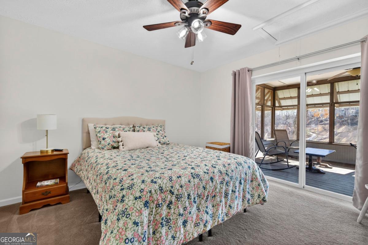 219 Hickory Pass Sparta, GA 31087 - Photo 27 of 62 a bedroom with a bed and a large window