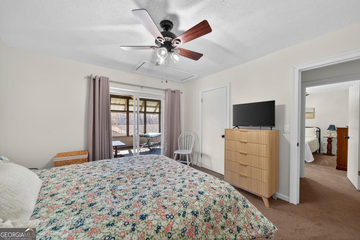 219 Hickory Pass Sparta, GA 31087 - Photo 28 of 62 a bedroom with a bed and a flat screen tv