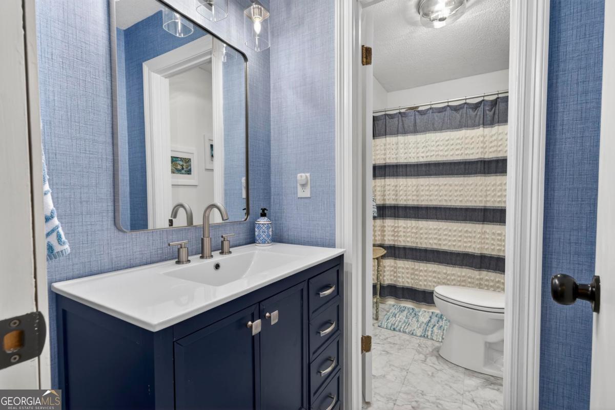 219 Hickory Pass Sparta, GA 31087 - Photo 30 of 62 a bathroom with a sink toilet and shower