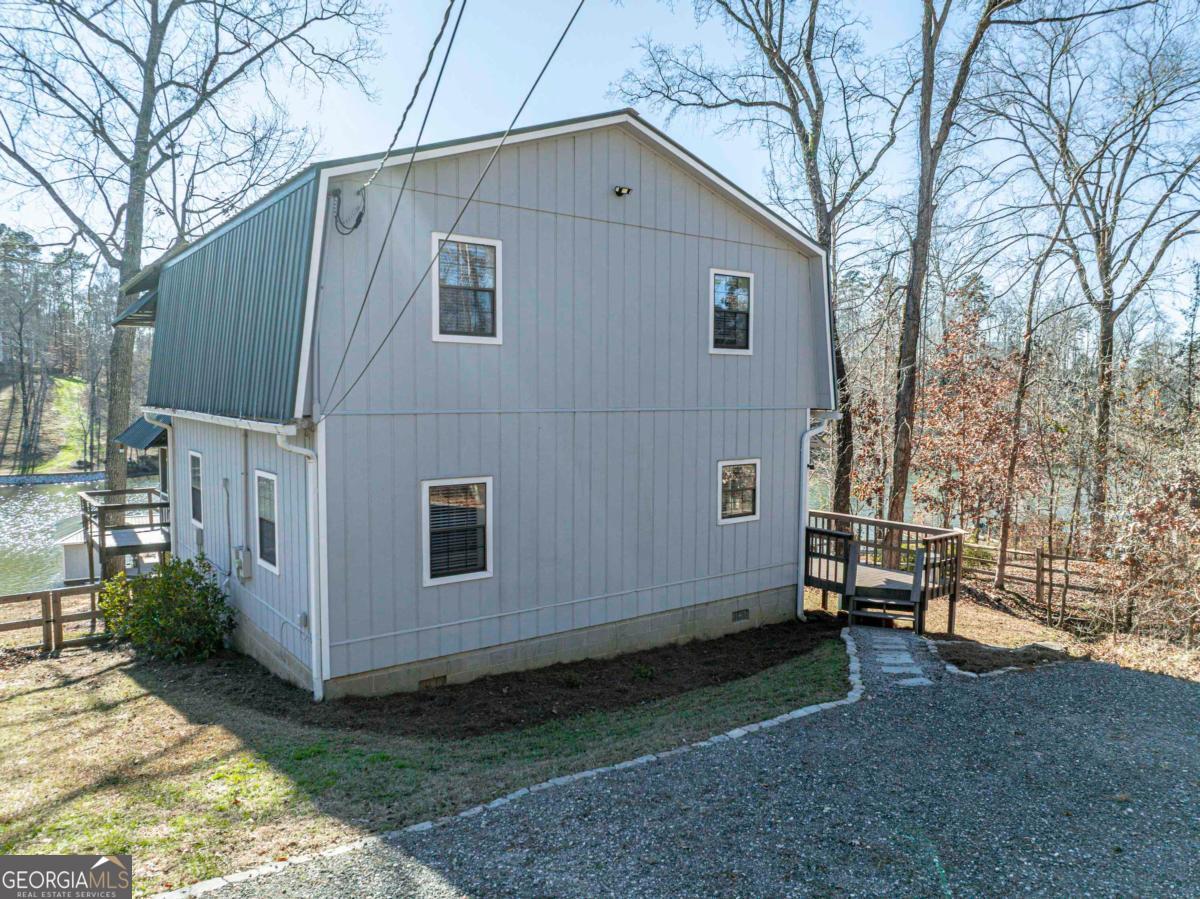 219 Hickory Pass Sparta, GA 31087 - Photo 42 of 62 a view of backyard with barbeque grill and wooden fence