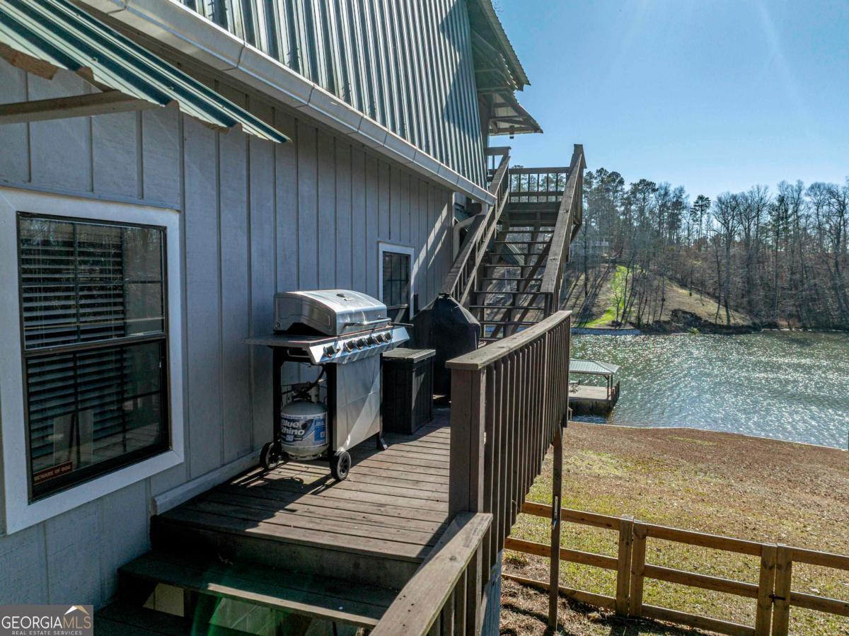 219 Hickory Pass Sparta, GA 31087 - Photo 44 of 62 a view of deck with wooden floor and outdoor seating