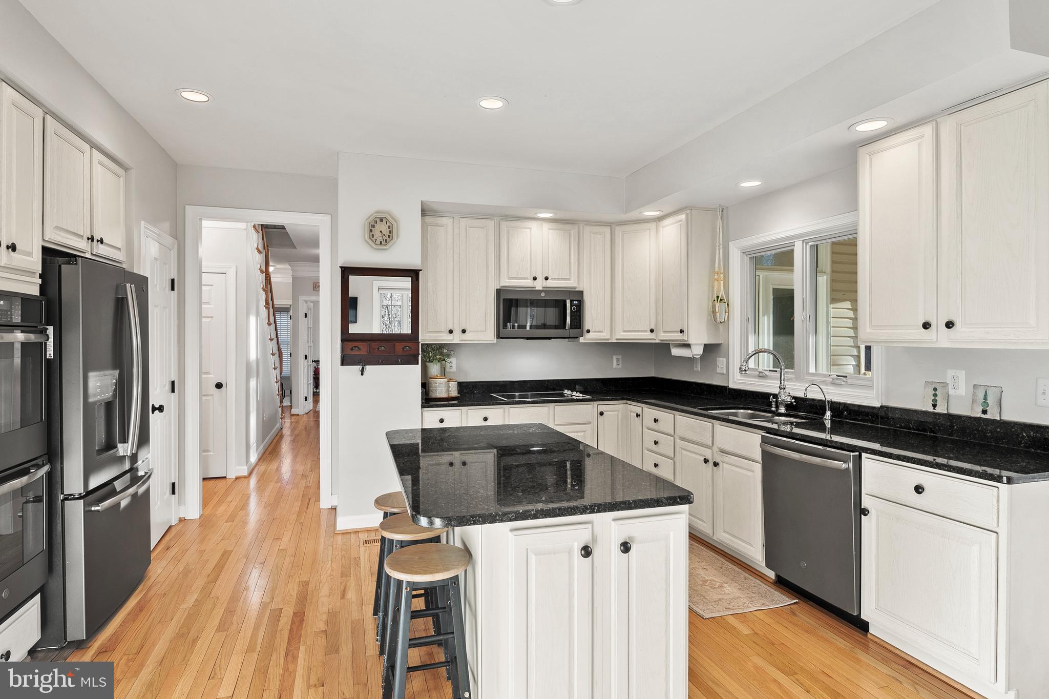 9916 Founders Way Damascus, MD 20872 - Photo 14 of 53 a kitchen with a sink a stove a refrigerator and cabinets