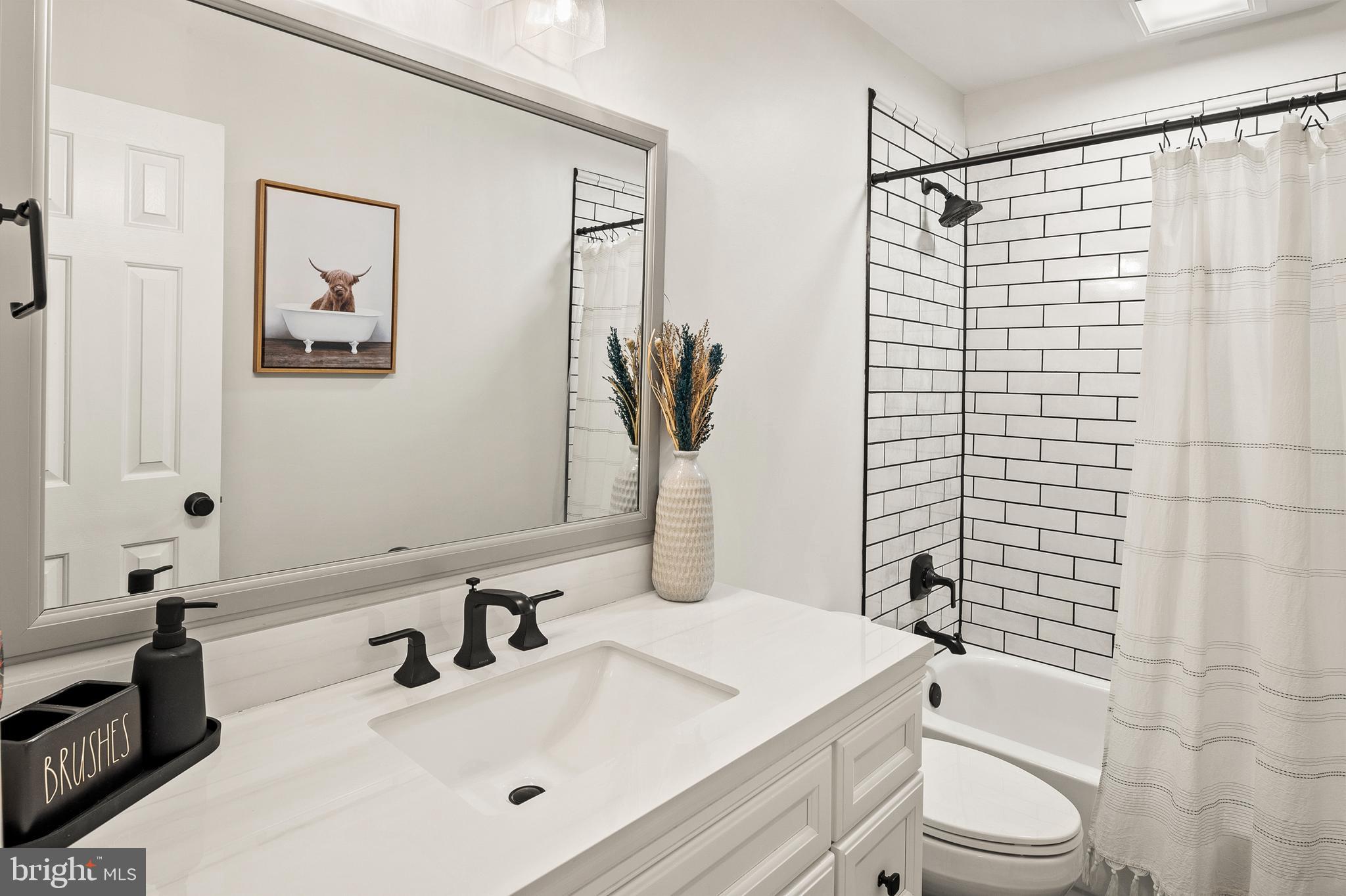 9916 Founders Way Damascus, MD 20872 - Photo 41 of 53 a bathroom with a sink toilet and shower