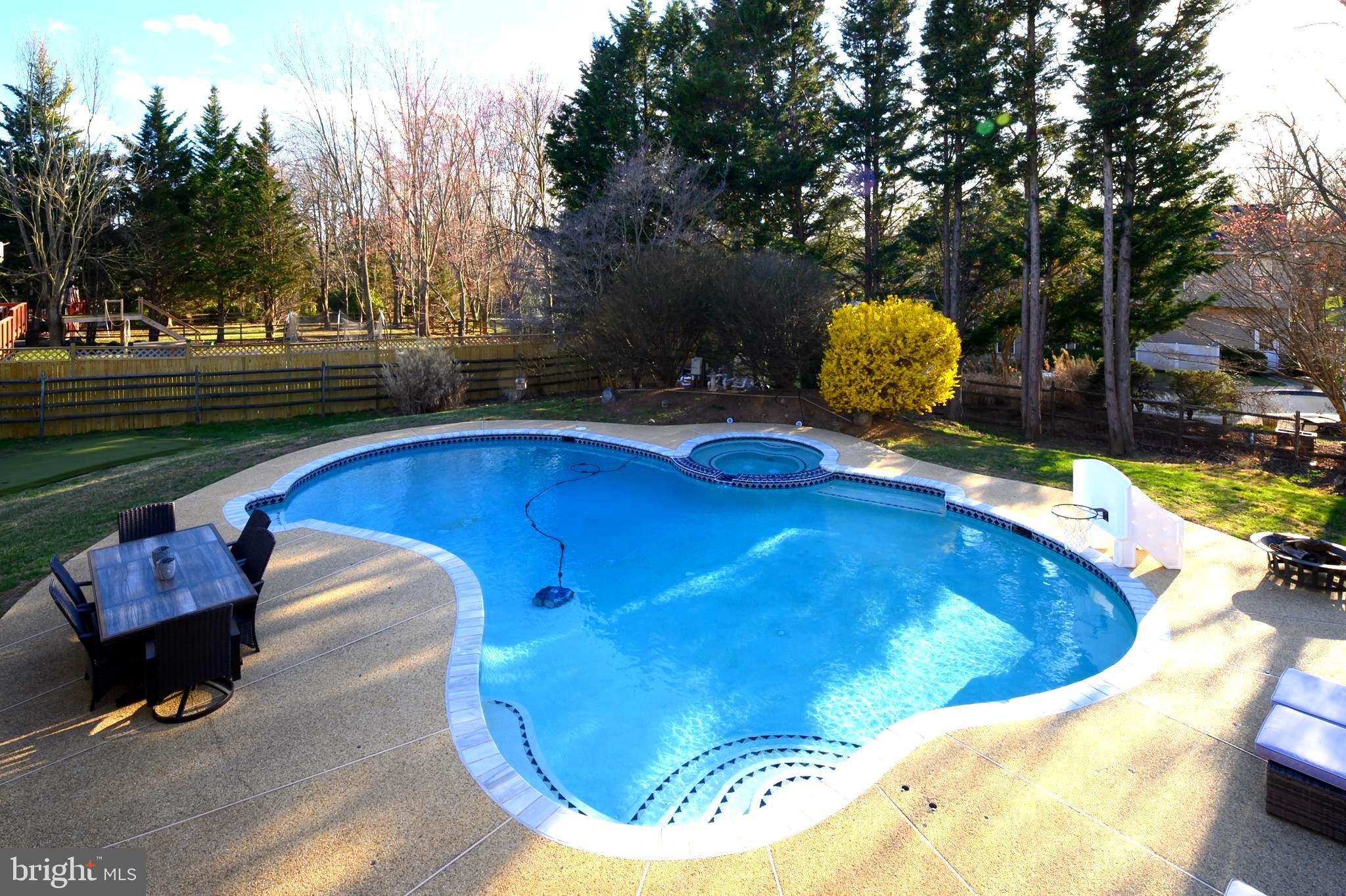 9916 Founders Way Damascus, MD 20872 - Photo 50 of 53 a view of a swimming pool with a patio and fire pit