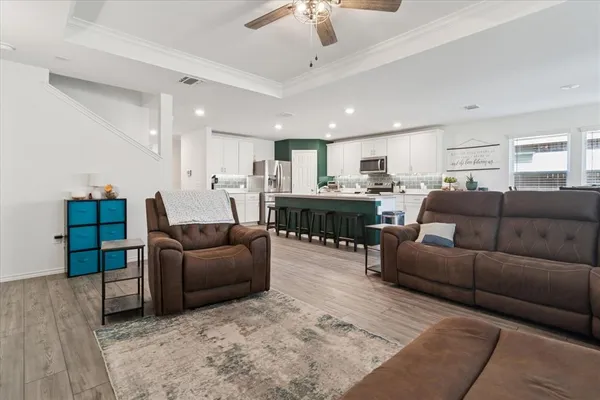 a living room with furniture and a chandelier