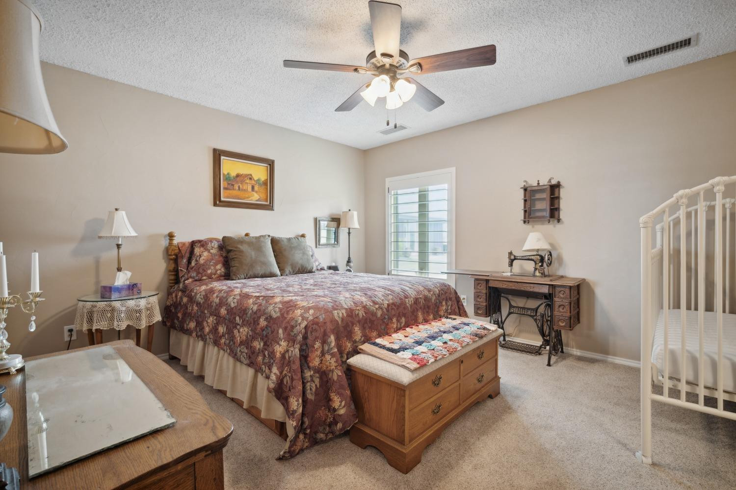 9002 Woodrow Road Wolfforth, TX 79382 - Photo 19 of 48 a bedroom with a bed couch and a window