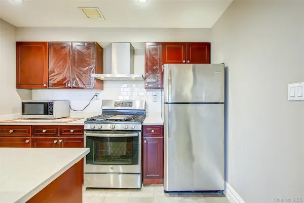 a kitchen with stainless steel appliances granite countertop a refrigerator stove and sink