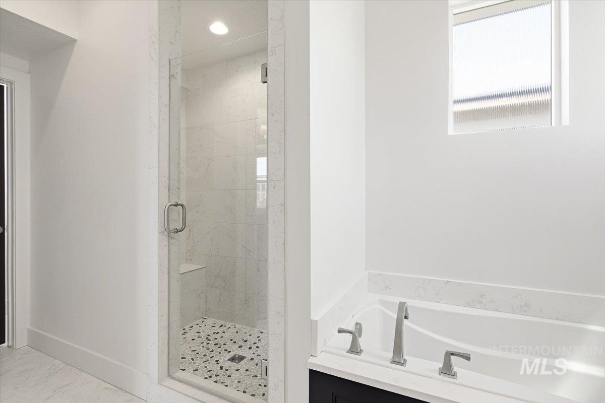 3794 South Single Tree Avenue Boise, ID 83716 - Photo 31 of 50 Glass-enclosed shower with pebble-style flooring and integrated bench