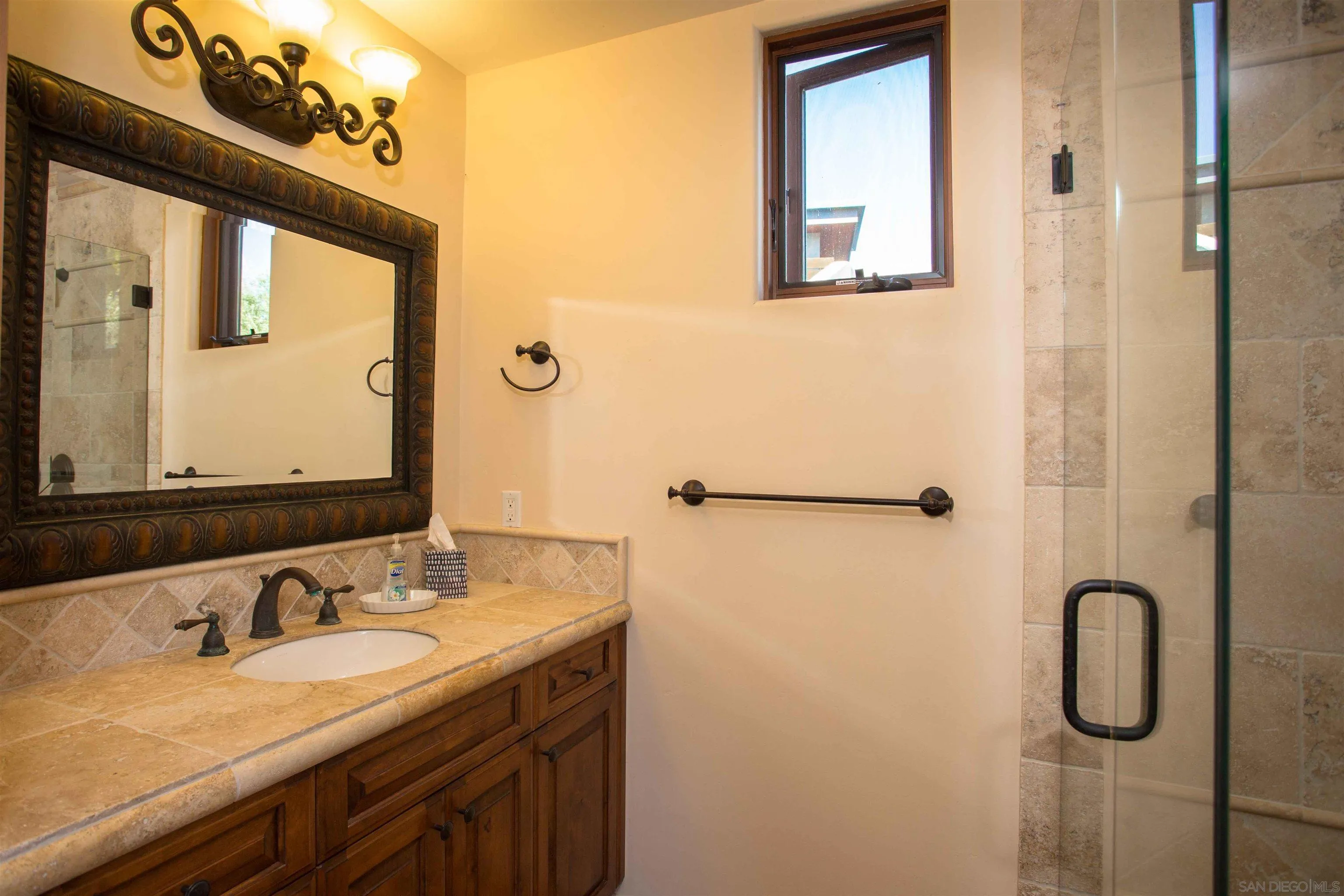 2624 Lone Jack Road Encinitas, CA 92024 - Photo 19 of 37 a bathroom with a granite countertop sink a mirror and a shower