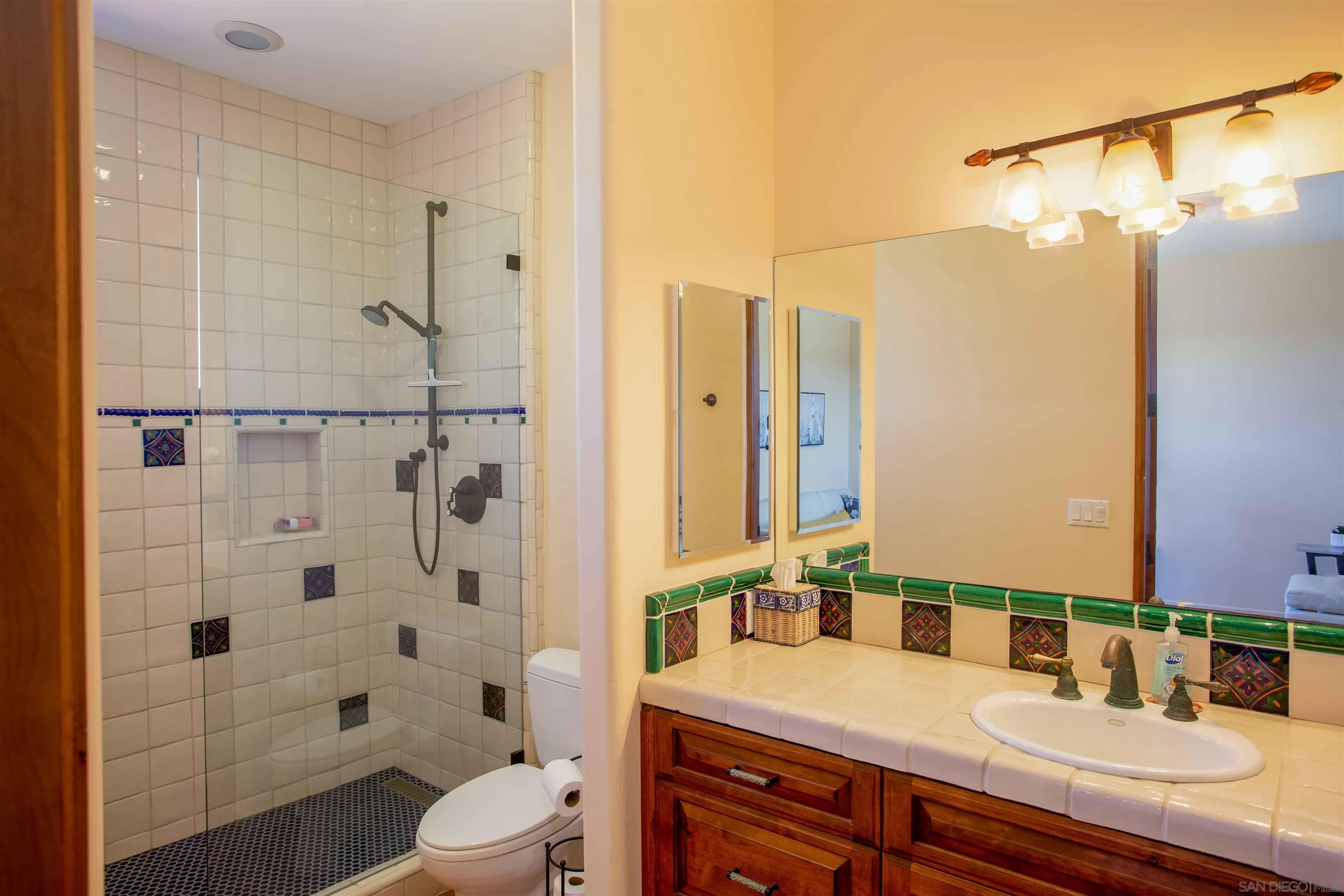 2624 Lone Jack Road Encinitas, CA 92024 - Photo 25 of 37 a bathroom with a granite countertop shower sink vanity mirror and toilet