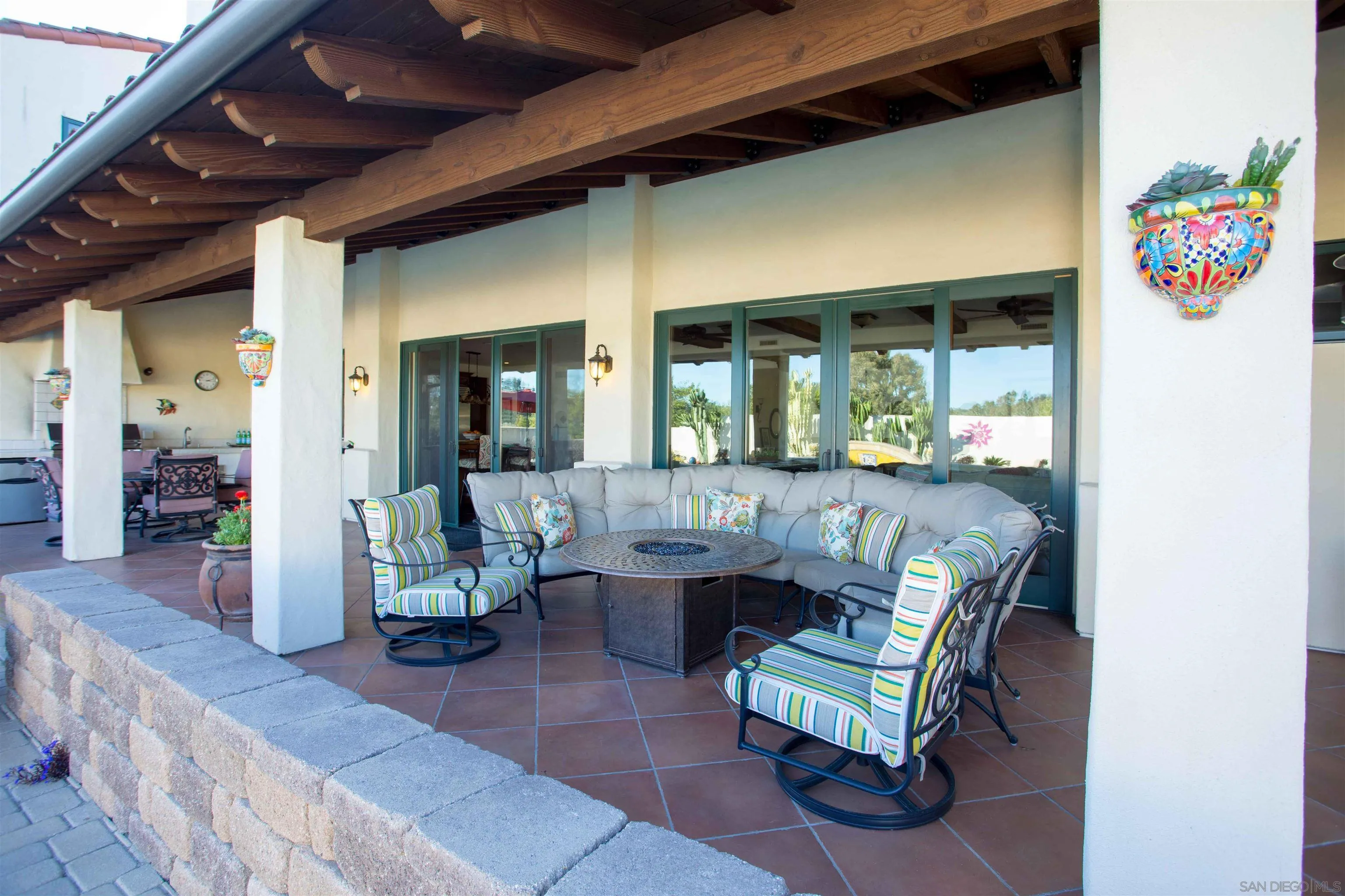 2624 Lone Jack Road Encinitas, CA 92024 - Photo 29 of 37 a living room with couches and a dining table with garden view