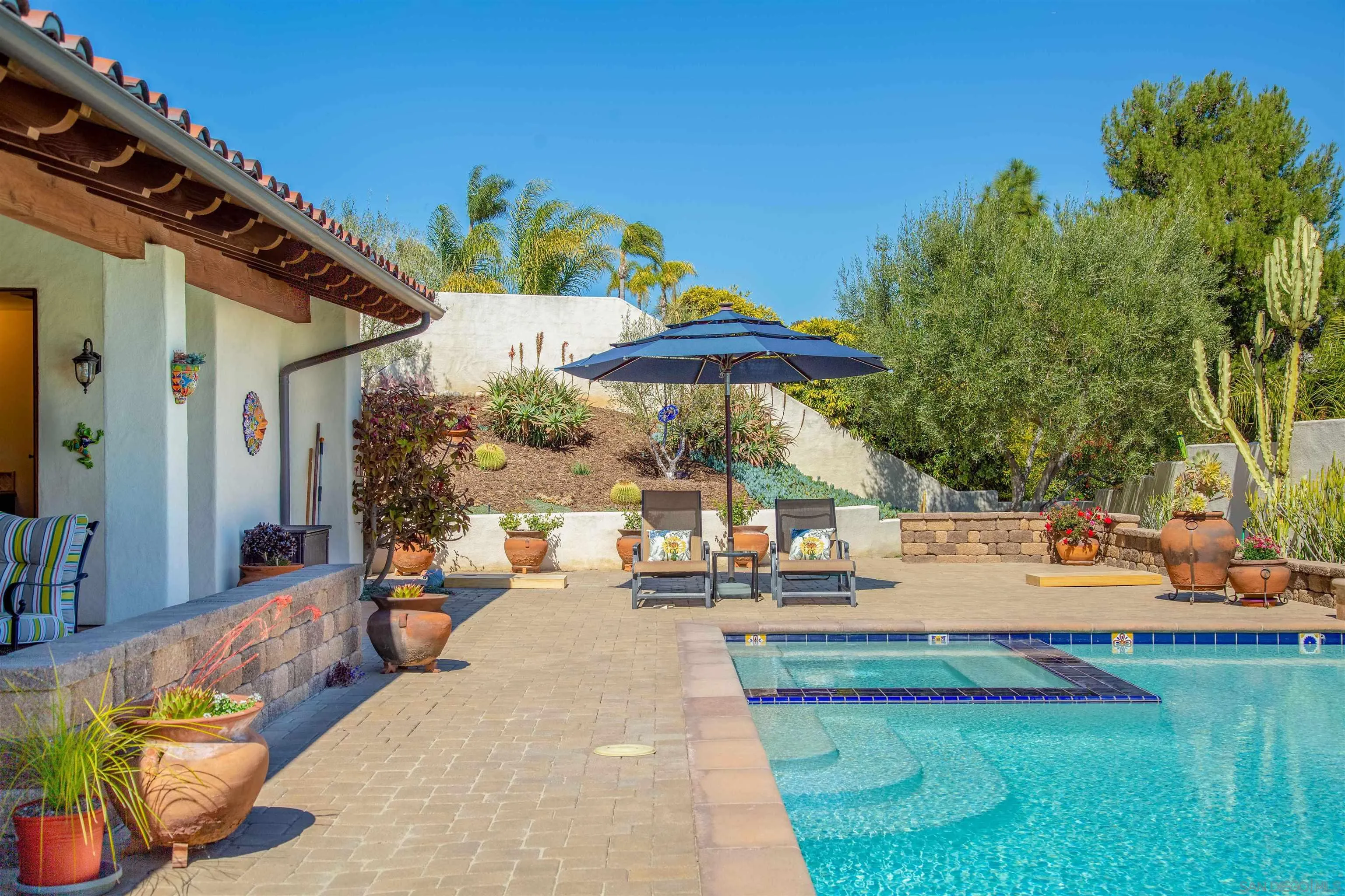 2624 Lone Jack Road Encinitas, CA 92024 - Photo 30 of 37 a view of a patio with couches and table and chairs with wooden fence