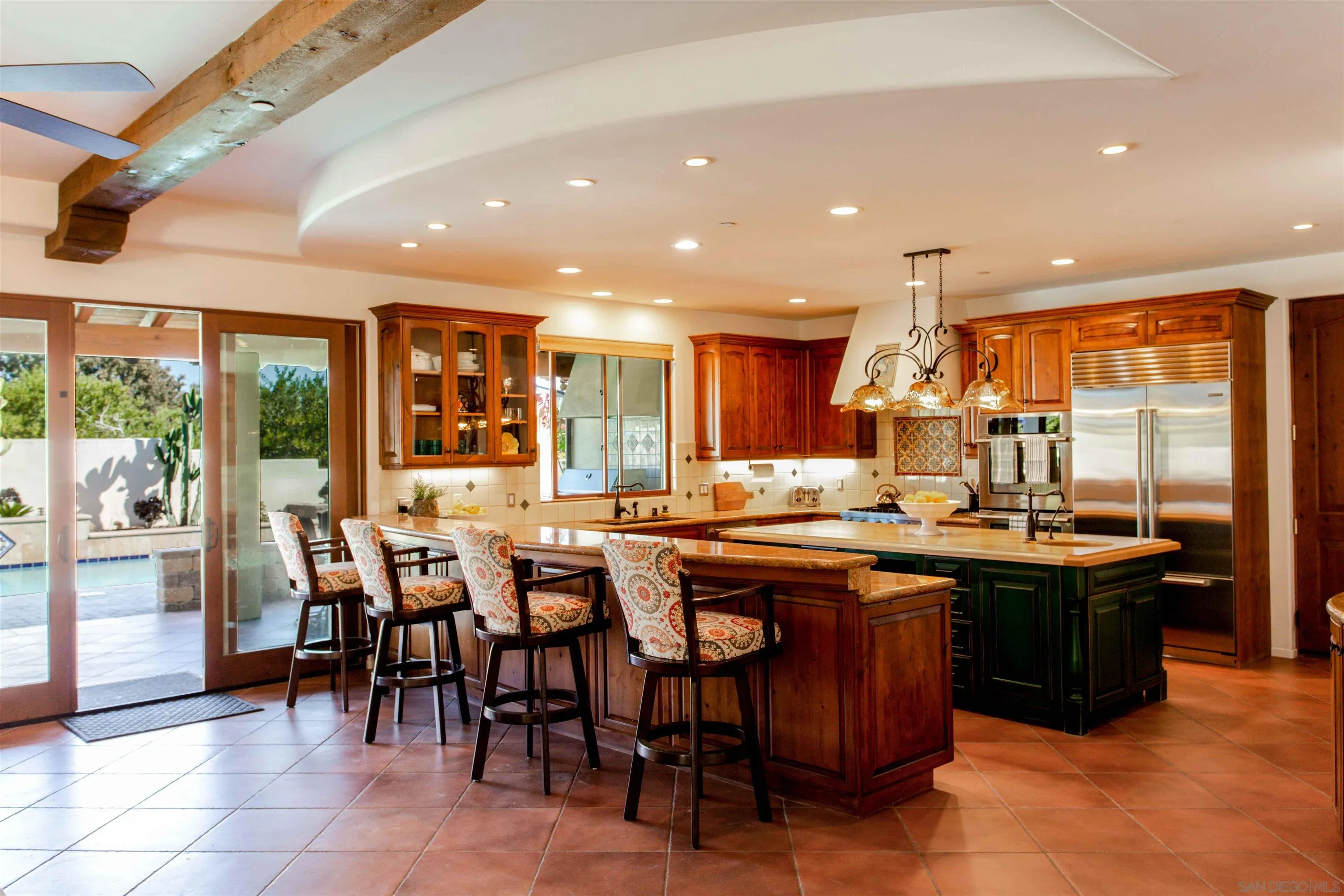 2624 Lone Jack Road Encinitas, CA 92024 - Photo 6 of 37 a kitchen with lots of wooden furniture dining table and chairs