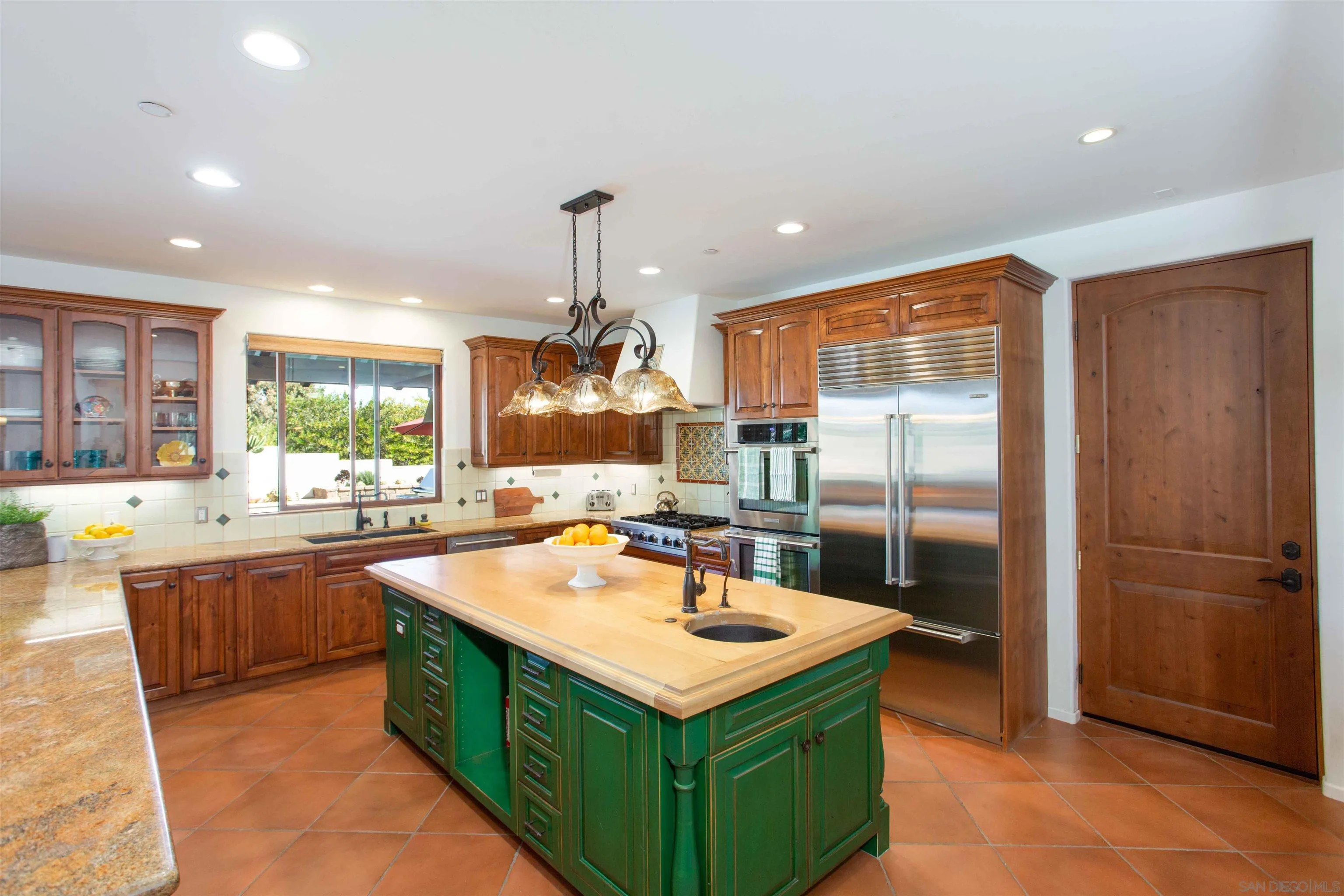 2624 Lone Jack Road Encinitas, CA 92024 - Photo 8 of 37 a kitchen with kitchen island a sink stove and refrigerator