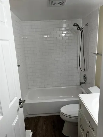 a bathroom with a shower a toilet and a sink