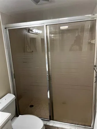 a bathroom with a shower and a toilet