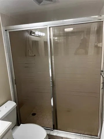 a bathroom with a shower and a toilet