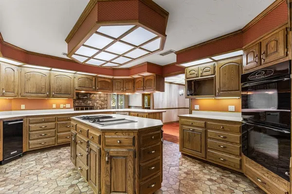 a kitchen with stainless steel appliances granite countertop a sink and cabinets