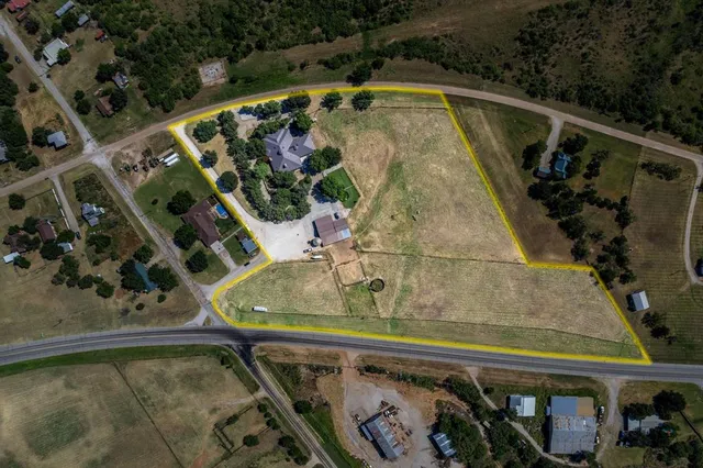 a view of swimming pool with seating area and trees in the background