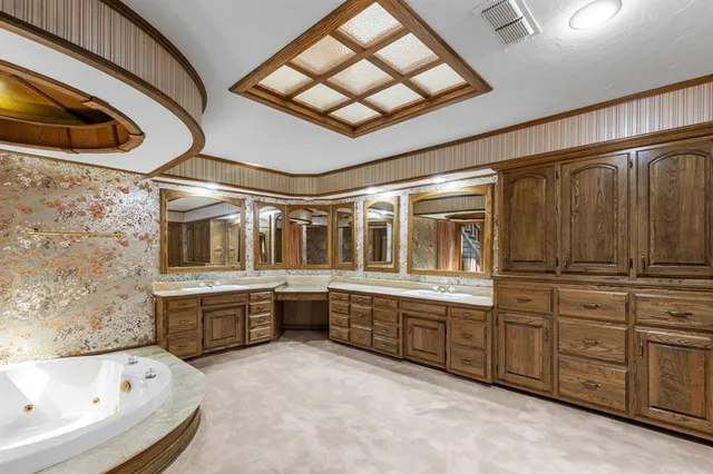 a large room with wooden cabinets and bathtub