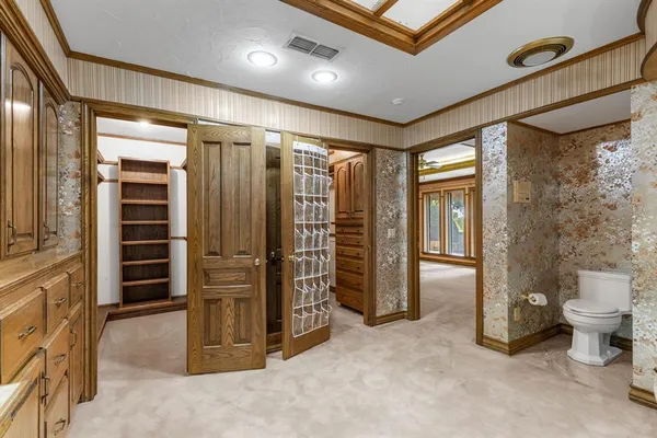 a view of an empty room and a bathroom