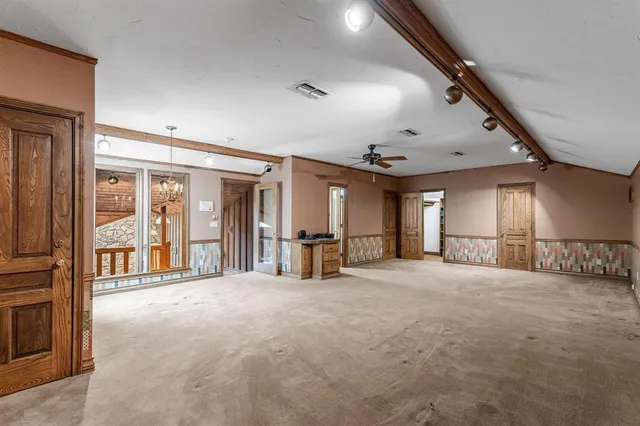 a large space with large windows and a chandelier