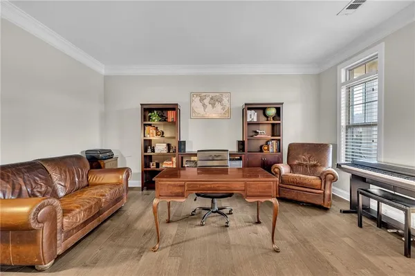 a living room with furniture and kitchen view