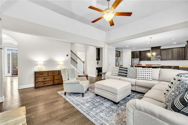 a kitchen with stainless steel appliances granite countertop a stove a refrigerator a kitchen island a table and chairs