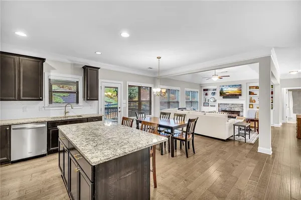 a bathroom with a granite countertop bathtub shower sink vanity mirror and toilet