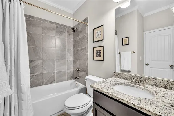 a bathroom with a granite countertop sink a mirror and a vanity