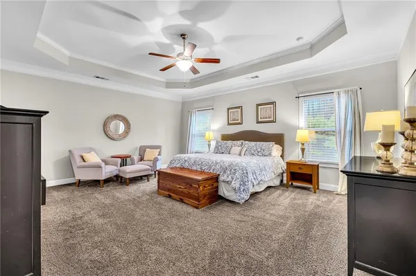 a bedroom with a bed and a chandelier