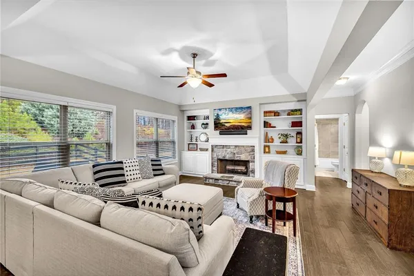 a living room with furniture fireplace and a large window