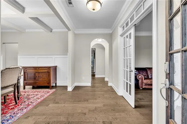 a dining room with furniture and a floor to ceiling window