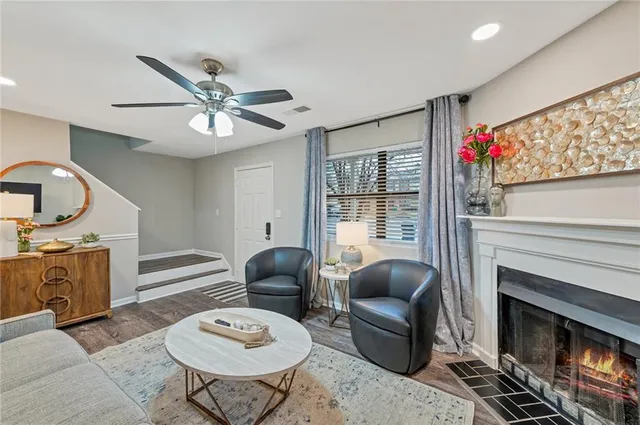 a living room with furniture a fireplace and a flat screen tv
