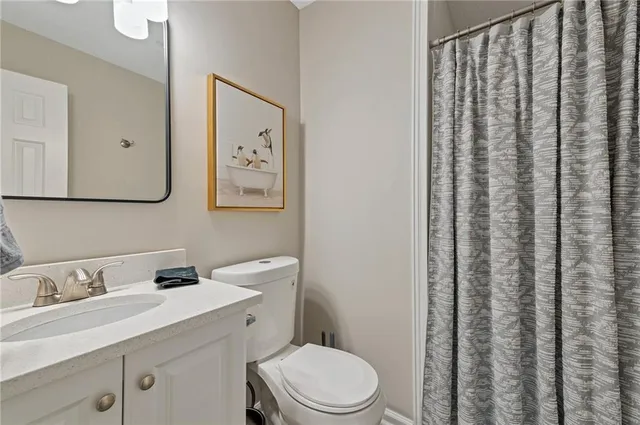 a bathroom with a sink a toilet and vanity