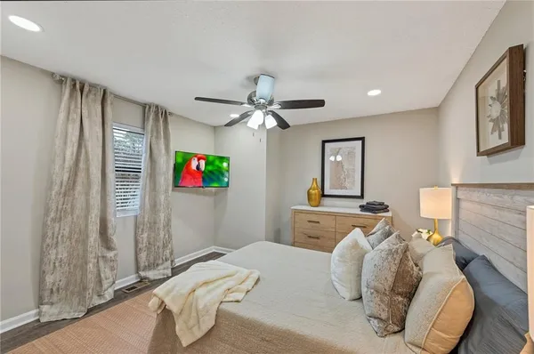 a bedroom with bed and a chandelier