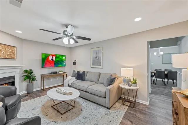 a living room with furniture a fireplace and a flat screen tv