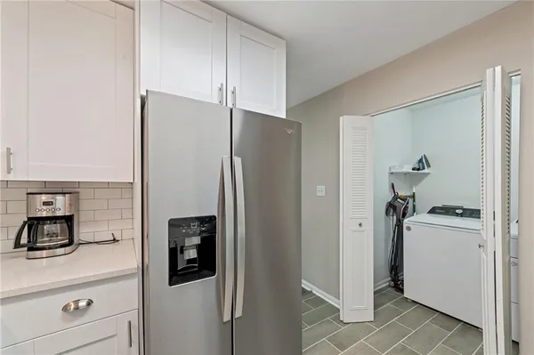 a kitchen with stainless steel appliances a refrigerator and cabinets