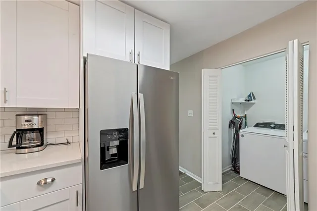 a kitchen with stainless steel appliances a refrigerator and cabinets