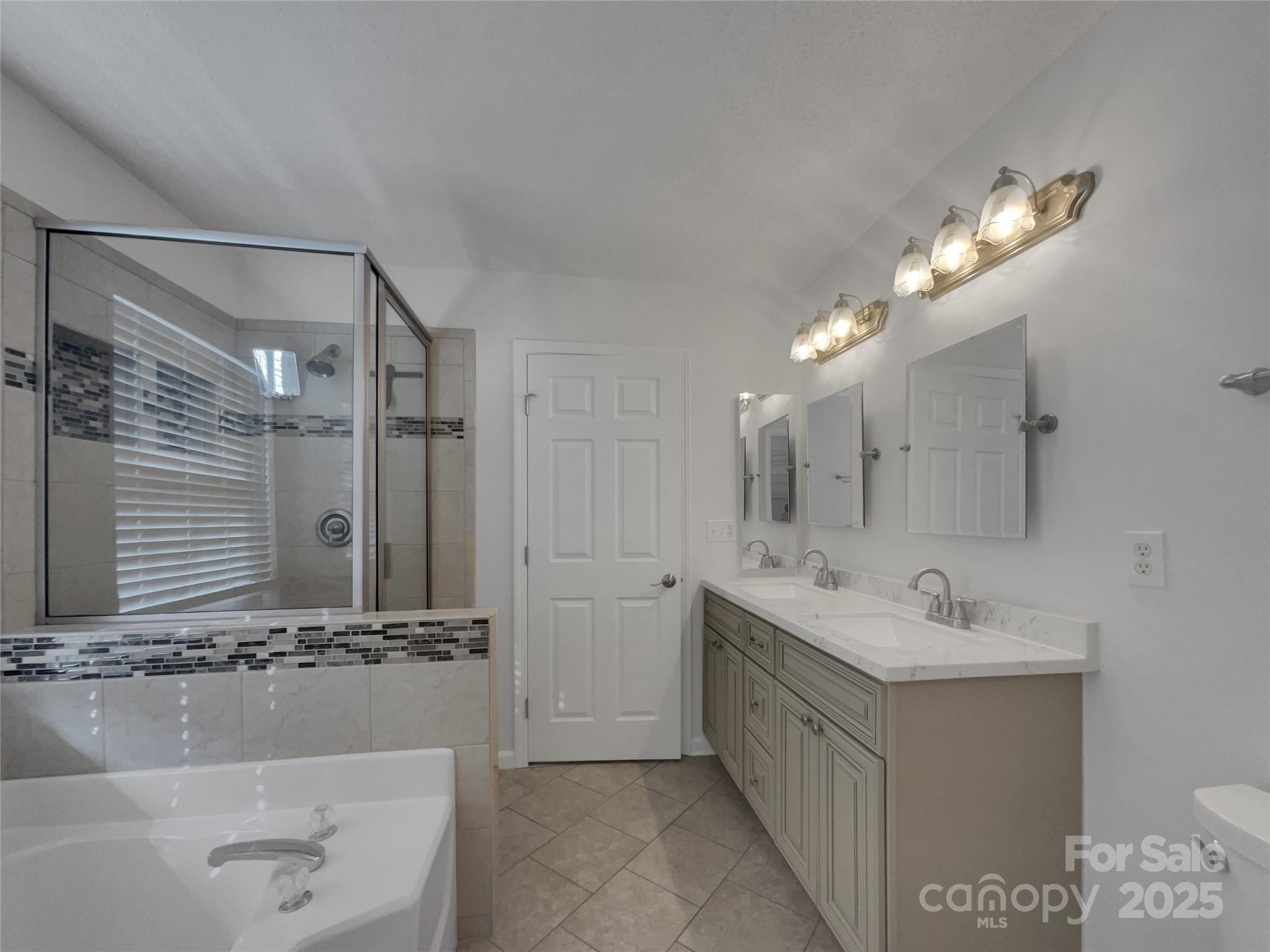 405 St George Road Fort Mill, SC 29708 - Photo 14 of 15 a bathroom with a double vanity sink a mirror and shower