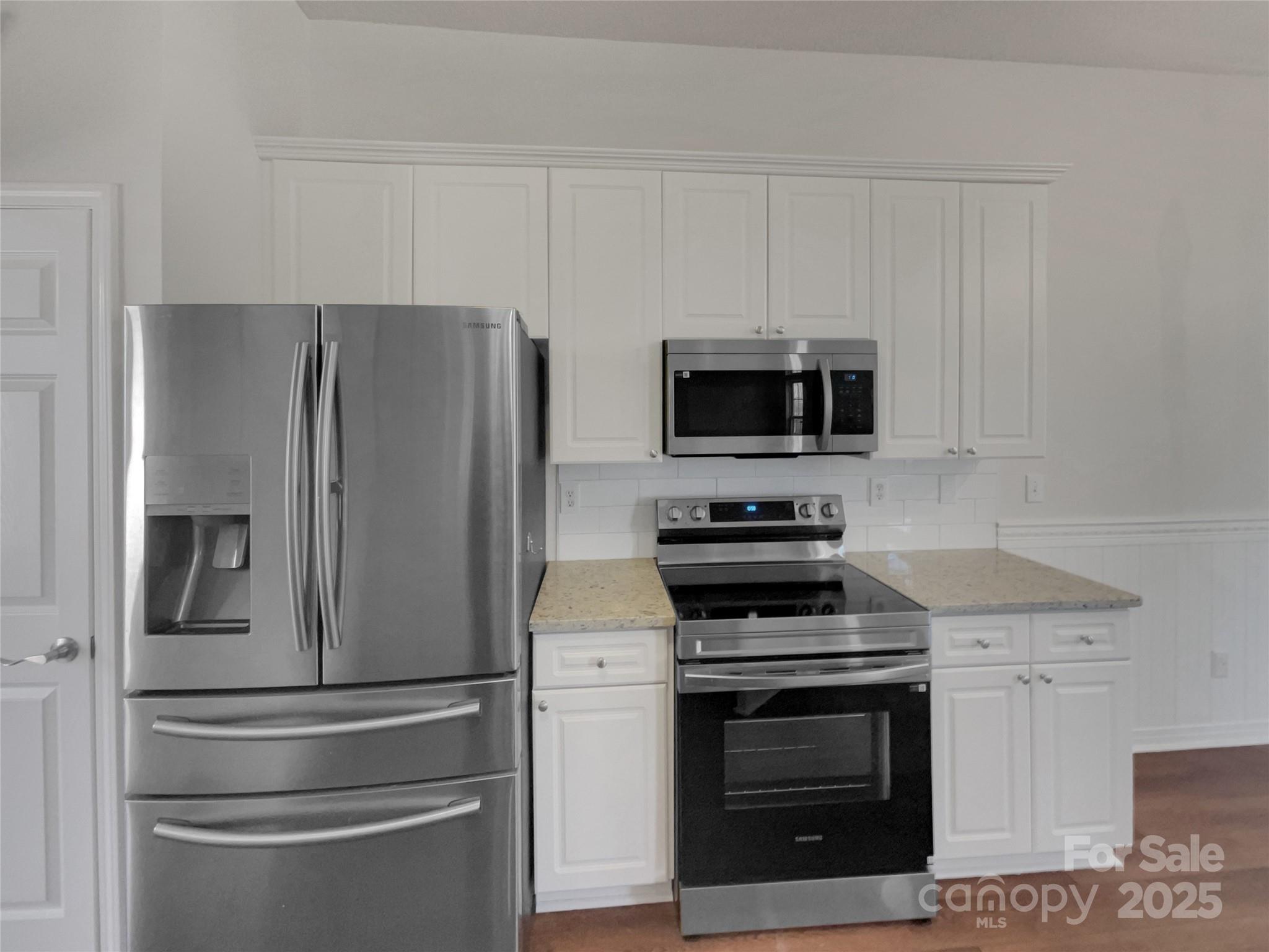 405 St George Road Fort Mill, SC 29708 - Photo 2 of 15 a kitchen with stainless steel appliances white cabinets and a stove top oven