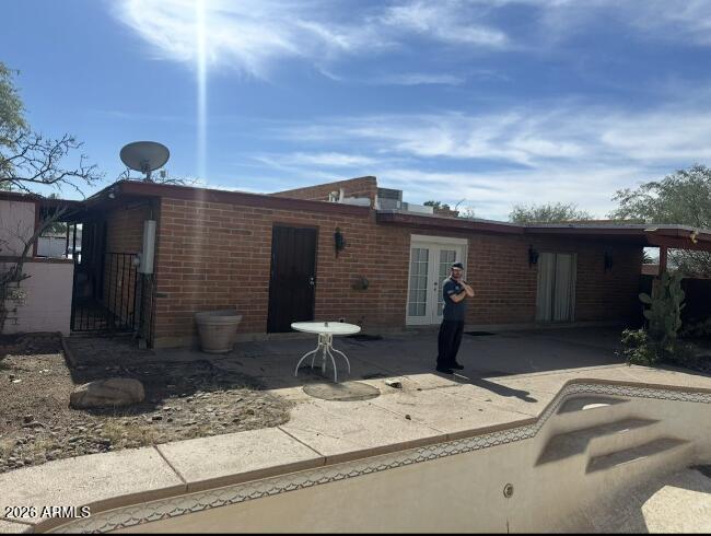 4260 West Mars Street Tucson, AZ 85741 - Photo 13 of 15 a front view of a house with patio