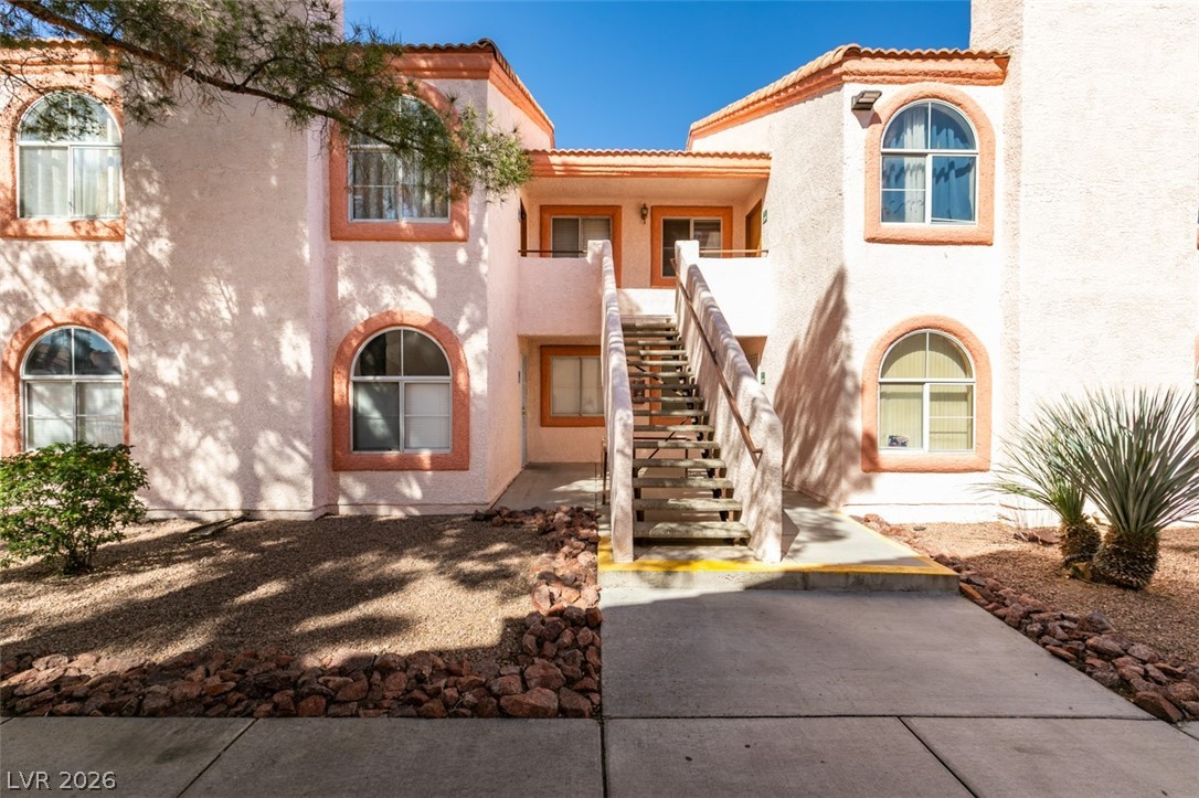 7570 West Flamingo Road, Unit 252 Las Vegas, NV 89147 - Photo 2 of 44 Arched windows and a tiled roofline adorn this multi-level residential structure.