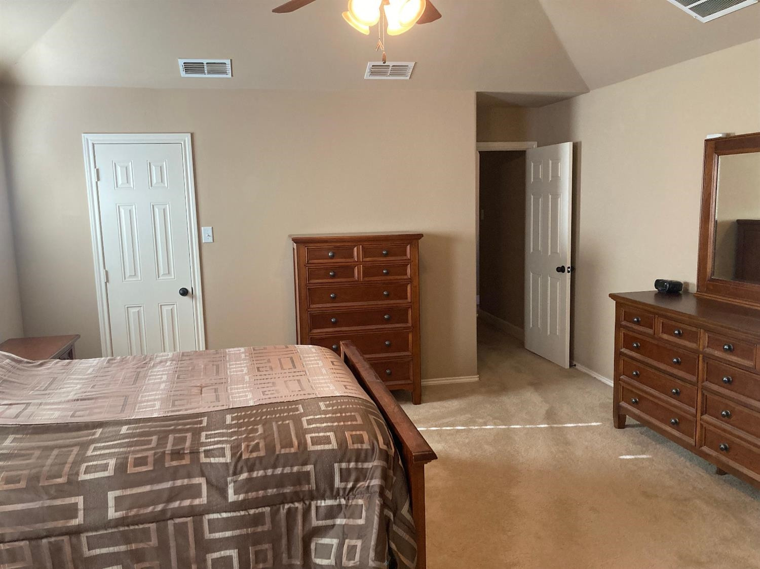 6120 75th Place Lubbock, TX 79424 - Photo 14 of 30 a bedroom with a bed and a dresser