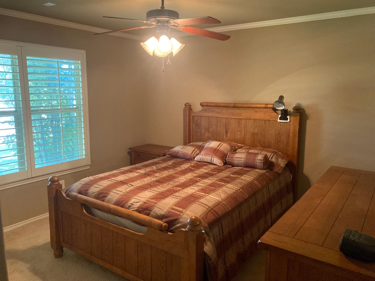 6120 75th Place Lubbock, TX 79424 - Photo 21 of 30 a bed sitting in a bedroom next to a window