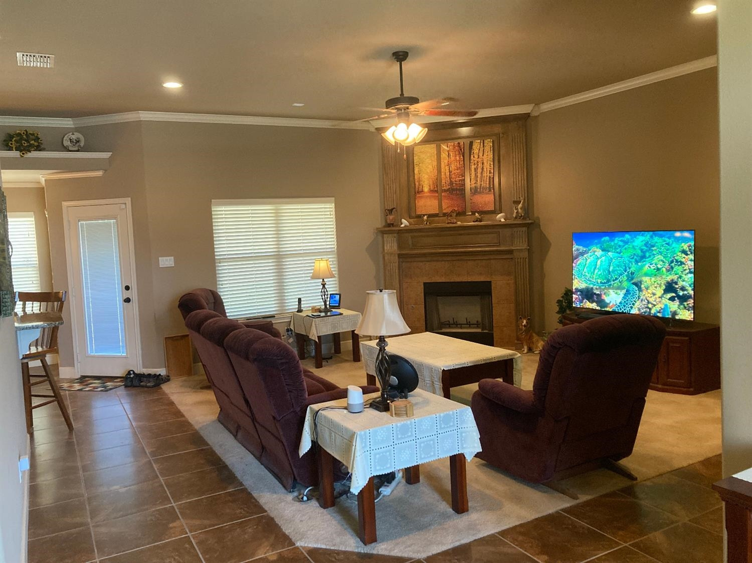6120 75th Place Lubbock, TX 79424 - Photo 4 of 30 a living room with furniture a fireplace and a chandelier