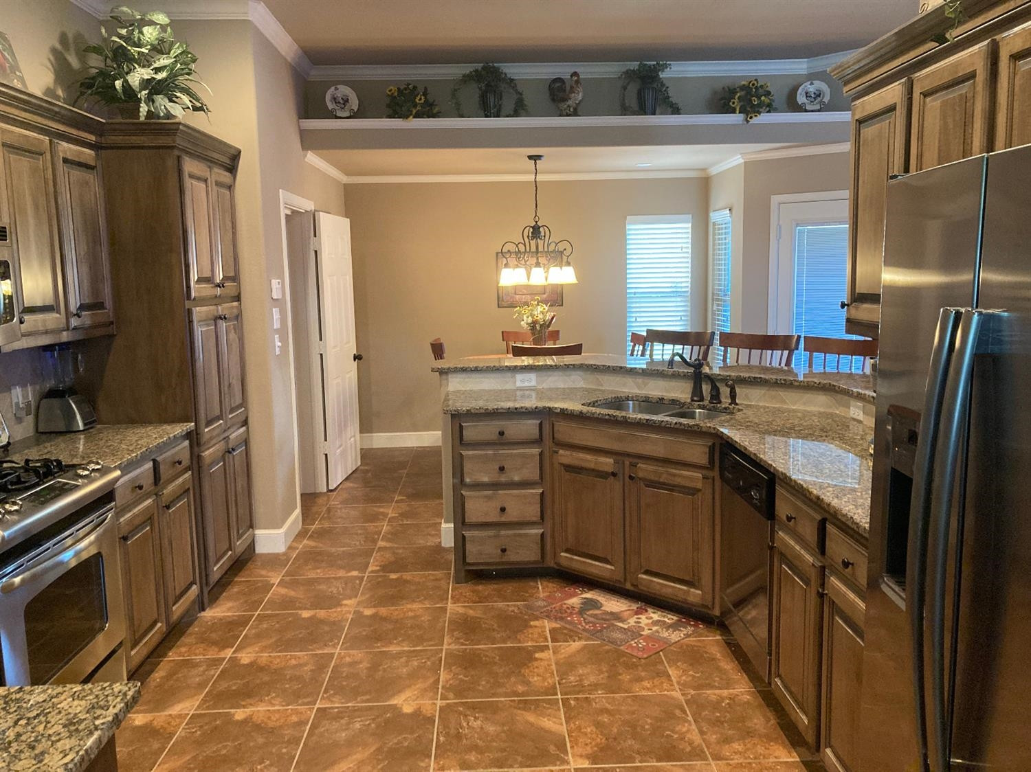 6120 75th Place Lubbock, TX 79424 - Photo 6 of 30 a kitchen with a sink stove and refrigerator