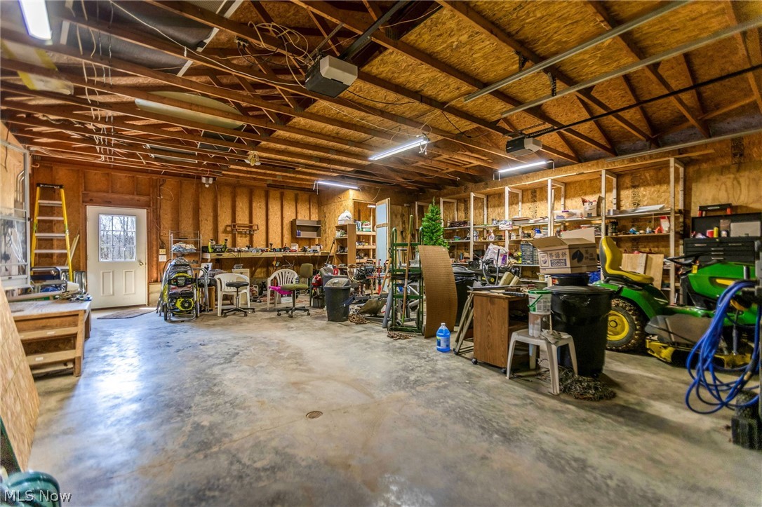 4502 Clover Road Cumberland, OH 43732 - Photo 25 of 38 Garage with a workshop area and a garage door opener