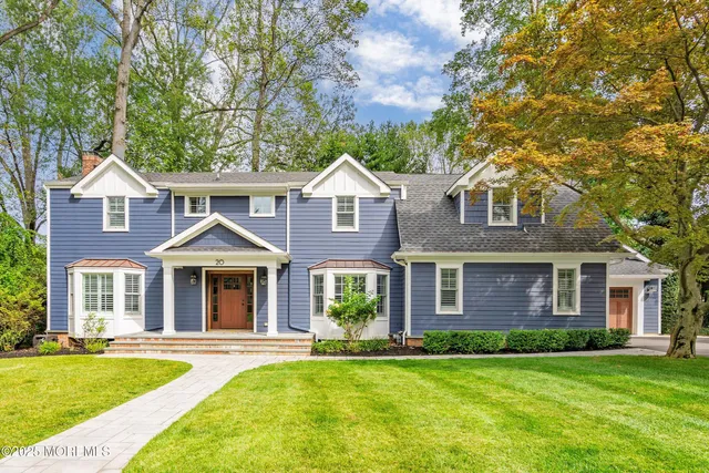 front view of a brick house with a yard