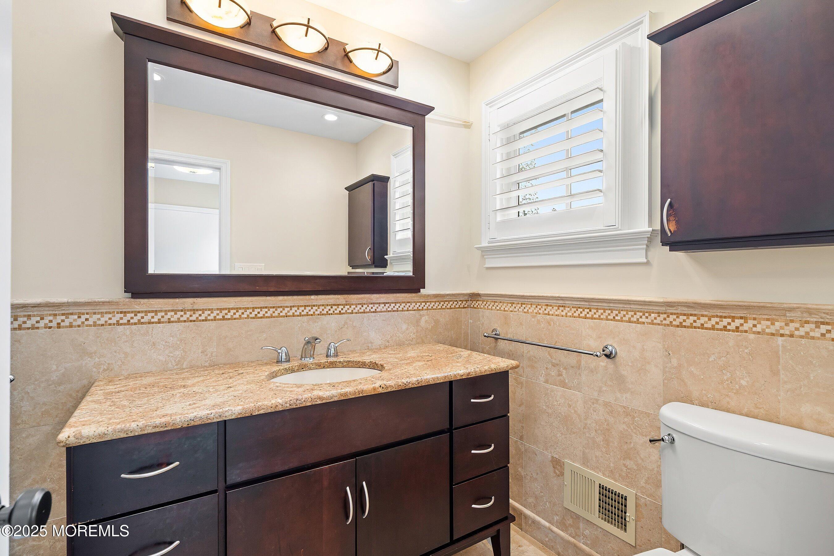 20 Rustic Terrace Fair Haven, NJ 07704 - Photo 19 of 32 a bathroom with a granite countertop sink a toilet and a mirror